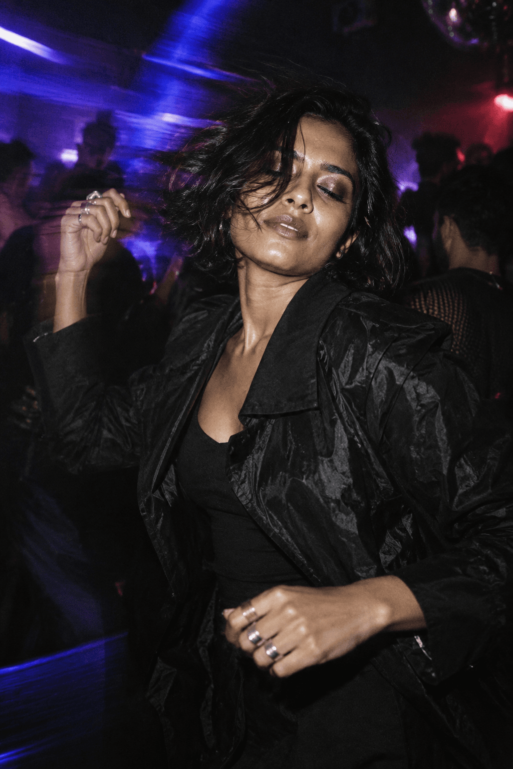 Flash-lit portrait of a dancer in the club